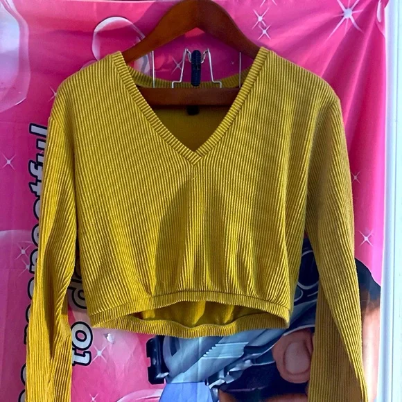it’s a yellow forever 21 crop top sweater, it’s super cute very